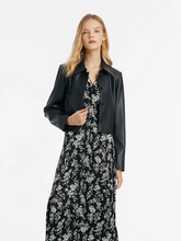 a lady in black eco-friendly leather jacket with floral printed maxi dress